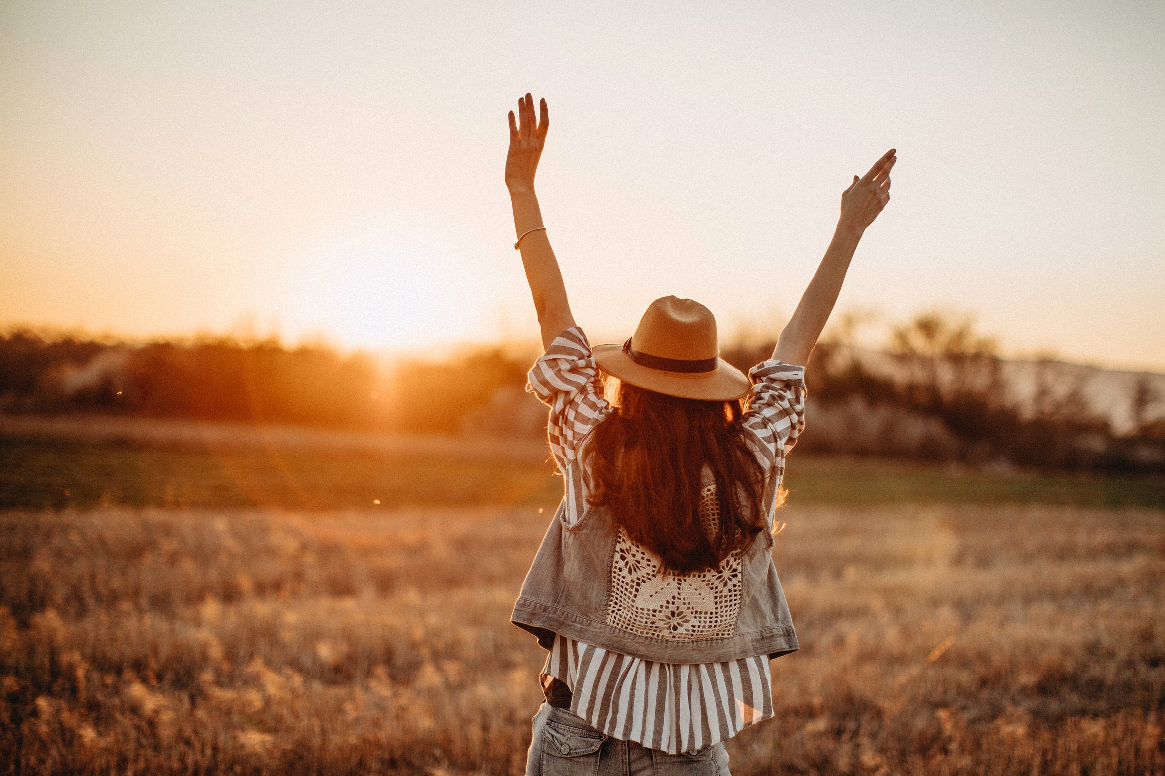 Peaceful woman having fun in meadow